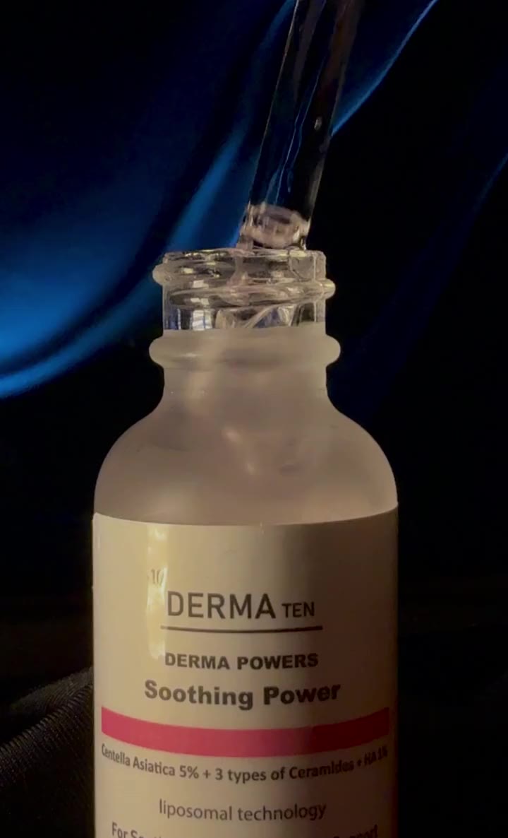 Serum falling from a dropper into a Derma Ten bottle, blue satin behind it